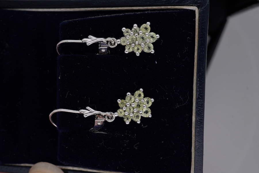 Two pairs of modern 375 white metal and gem set drop earrings, including pear shape, 30mm and star cluster, gross weight 4.4 grams. Condition - fair to good